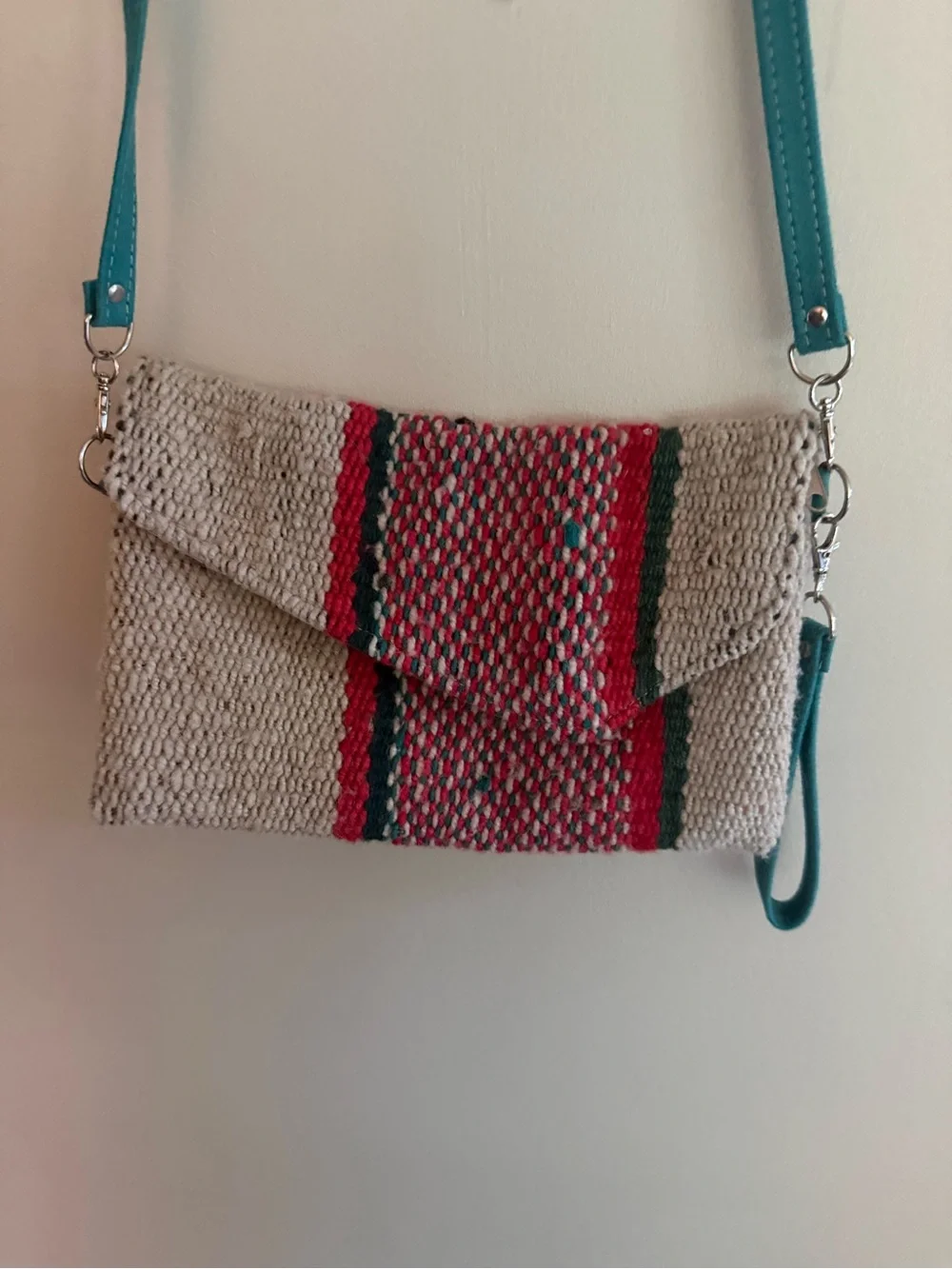 Handwoven Beige Crossbody Bag with Turquoise Strap and Red Accent